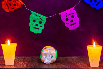 Day of the dead background decorated with alfeñique skull and candles