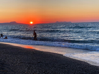 summer sunset on the sea coast in Creta, Greece, at 02 August 2023. Beautiful sunset by the sea in...