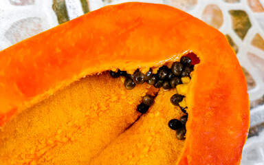 Half papaya in hand with background in Mexico.