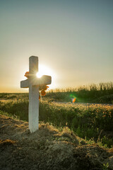 Cross with the sun and flowers in remembrance of a deceased person
