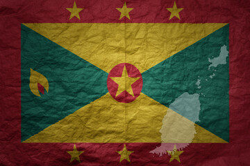 big national flag and map of grenada on a grunge old paper texture background