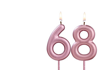 Candle number 68 - Lit birthday candle on white background