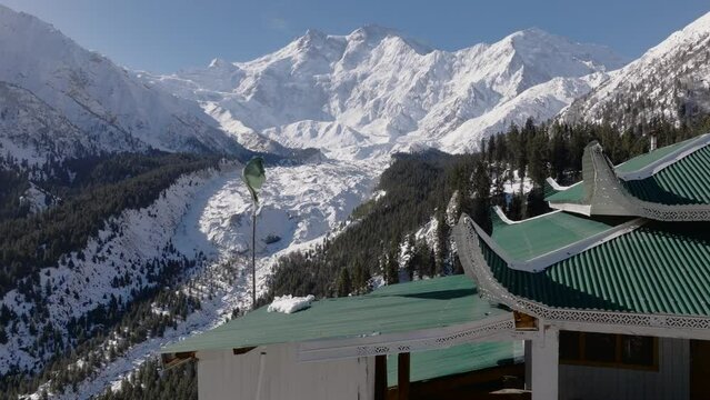 Snowy Nanga Parbat at Winter. Flag of Pakistan floating on foreground, Fairy Meadows Pakistan, Mount Killer at Dawn