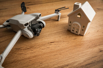 Drone camera next to a ceramic model house ones privacy UAV surveillance, home security government...
