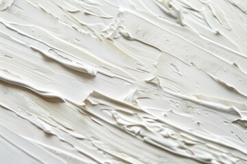 Abstract close-up of textured white paint strokes applied on a canvas, showcasing the dynamic...