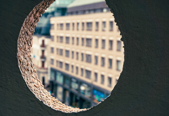 view of a city seen through a circle hole