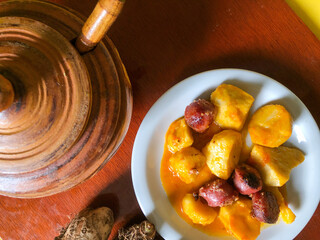 medium-cooked yam with Calabrian sausage sauce on a white porcelain plate