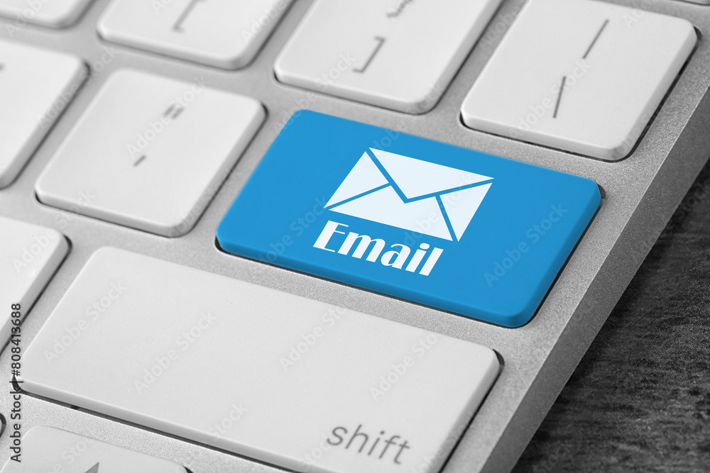 Aufkleber light blue button with word email and illustration of envelope on computer keyboard, closeup