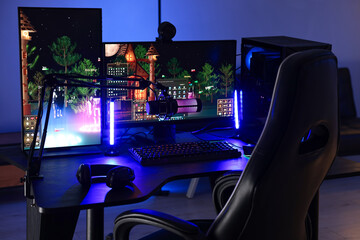 Playing video games. Stylish room interior with modern computer and gaming chair in neon lights