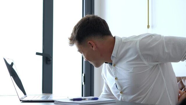 Young man working from home on a laptop in a modern home office, focused and productive, representing remote work, freelance lifestyle, and digital entrepreneurship.