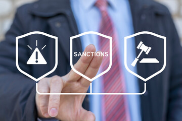 Politician or business man working on virtual touch screen presses word: SANCTIONS. World economic...