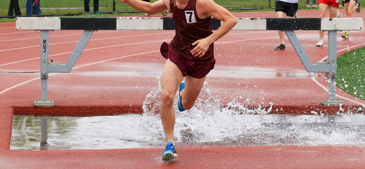One runner running out of the water during a steeplechase race