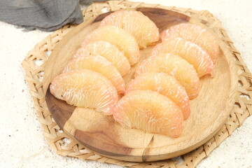 Fresh Peeled Pomelo (Jeruk Bali), Grapefruit or Shaddock on a Plate,White Background