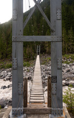 Metal Tower Frames the Wooden Deck Of The Carbon River Suspension Bridge