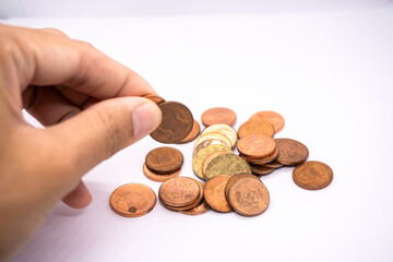 Hand holding coins for home budget planning, saving money, and business growth in the context of currency, economics, work, jobs, tasks, fairs, services, and the stock market