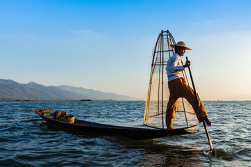 Myanmar travel attraction landmark - Traditional Burmese fisherman at Inle lake, Myanmar famous for their distinctive one legged rowing style © Dmitry Rukhlenko