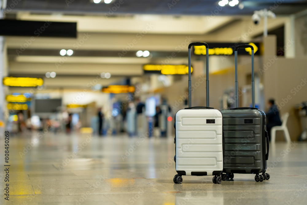 Wall mural travel, two suitcases in an empty airport hall, traveler cases in the departure airport terminal wai