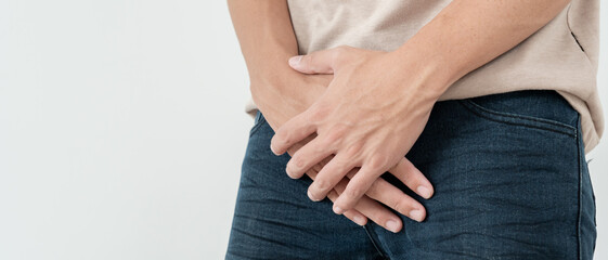 Man hold hand in front of private parts feeling discomfort from disease and inflammation. Venereal,...