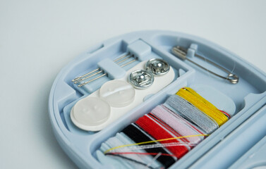 Compact travel small sized tailoring or stitching tools equipment in plastic blue container...