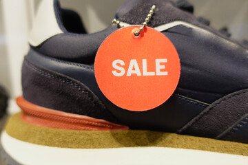  Men sneaker with red sale sign displaying on shelf 