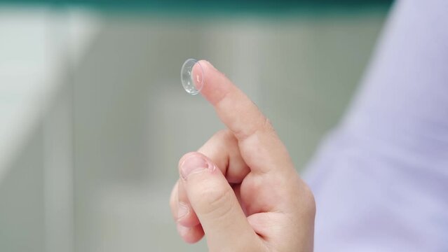 Contact lens close-up on a child's finger. Modern methods of treatment and correction of vision in children. Advertisement for clinics and medical products. Optometry

