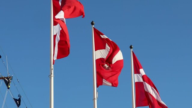 Stockholm, Sweden Danish flags on flagpoles blowing in the wind. 