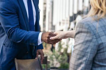 multiracial business people shaking hands