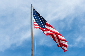 American flag waving in the wind. Flag of the USA. National waving flag of united states on sky....