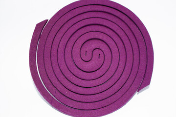 violet spiral Mosquito Repellent coil isolated on white background, A mosquito coil is a...