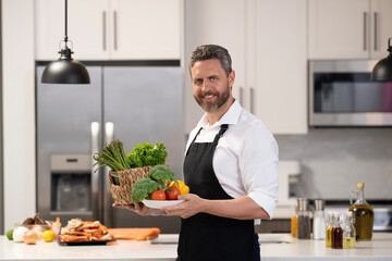 Chef cook man preparing food. Man cook food in modern kitchen. Cooking healthy salad. Chef cooking in apron. Man cook cooking at kitchen. Master basic cooking techniques