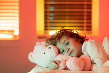 Child go to sleep in the night in the bedroom. Cute little boy asleep in bed.