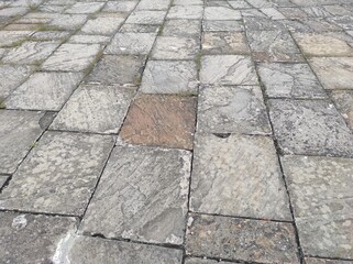 Cobblestone texture. Gray paving stones outside close-up. Design blank