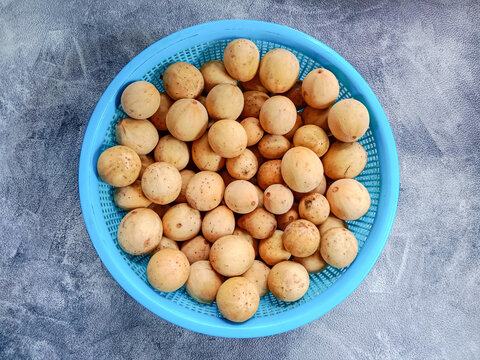 Langsat fruit in a basket. Langsat, lanzones or longkong (Lansium parasiticum). Pile of langsat fruit