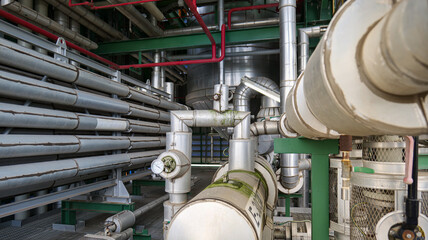 A large pipe system with a green pipe in the middle