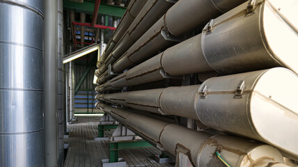 A long row of pipes are lined up in a factory