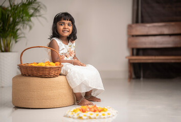 Happy Onam 2024 image Cute girl kid with Onam pookalam
