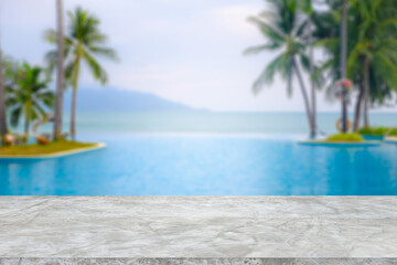 Cement counter top There is a view of the swimming pool and sea in the background of the resort. A...