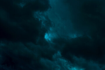 Dramatic stormy sky background. Dark green fluffy cloudy sky. Halloween cloudscape background...