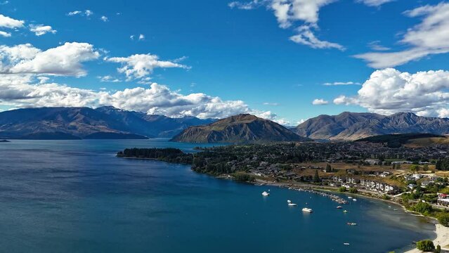 Wanaka Lakefront and Roys Bay New Zealand on sunny day, aerial dolly hyperlapse