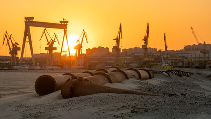 Industrial landscape:sunset over industrial areas,pipelines running through sandy desert