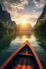 Fototapeta premium A boat is on a lake with mountains in the background. The sun is setting, casting a warm glow on the water