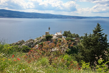 Little medieval stone church in Croatia on the cliff above Adriatic sea