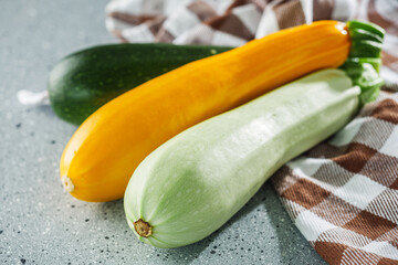 fresh natural zucchini on a light stone background