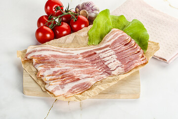 Sliced pork bacon oved board