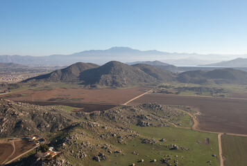 Daytime aerial view from hot air balloon of fields and foothills in Temecula southern California...