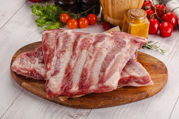 Raw pork ribs over board