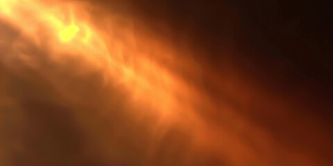A blurred golden light with a dark background, close up of fire in the night	