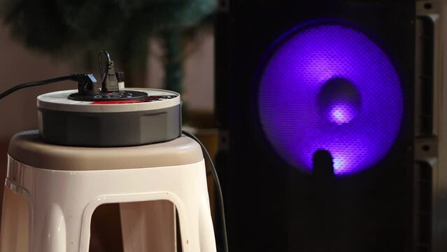 An hub for electric equipments, in the background the speaker changes colors