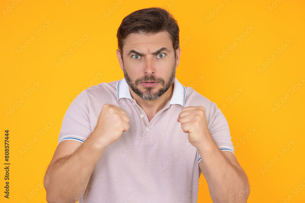 Wall mural portrait of angry man screaming. portrait of young angry man isolated on yellow background. angry ma