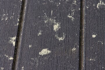 Pine pollen on the surface of rattan furniture, allergen and allergic reaction to tree dust.